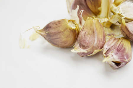 Disassembled head of garlic on white background with copy space.の写真素材