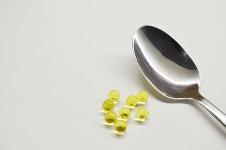 Spoon and tablet on white background. Healthy lifestyle meal flat lay. Medicine food vitamins conceptの写真素材