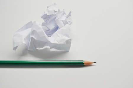 crumpled up paper wads and pencil, isolated on white background. Writing concept.の写真素材
