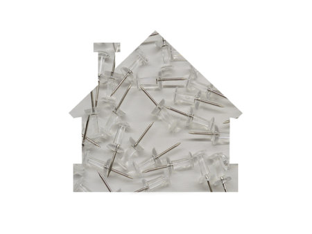 Lots of pushpins on a white background. Shot through the cut-out silhouette of the house.
