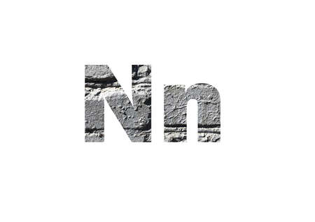 gray brick background. Shot through the cut-out silhouette of the letter N.の写真素材