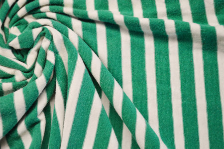 Green with white stripes textile as a background. Close up on Green with white stripes material texture on fabric. crumpled fabric textureの写真素材