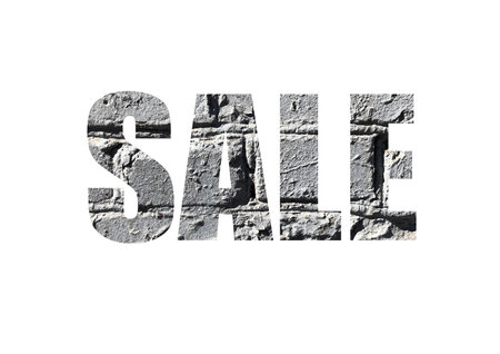 gray brick background. Shot through the cut-out silhouette of the word SALE.の写真素材