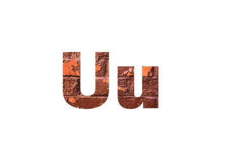 Brown texture brick wall. Shot through the cut-out silhouette of the letter Uの写真素材