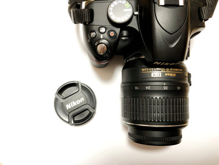 Moscow, Russia, May 2021, Nikon camera with lens on white background.