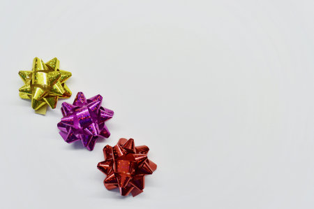 Set of three shiny bows for gifts on a white background with copy space.