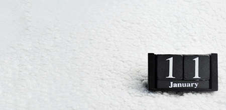 Wooden calendar from blocks on a white textile background with copy space. Banner. 11th of January. International Day of thank youの写真素材