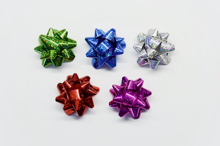 Set of five shiny bows for gifts on a white background.