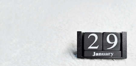 Wooden calendar from blocks on a white textile background with copy space. Banner. 29th of January. Mobilization Day Against the Threat of Nuclear War. Automobile Invention Day or World Automobile Dayの写真素材