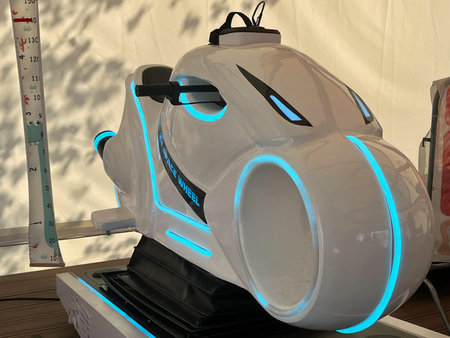Futuristic white ride-on vehicle with glowing blue accents, designed for entertainment, showcasing...