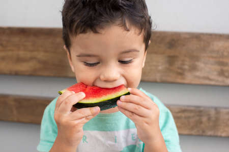 Child eating watermelon (close up)の写真素材