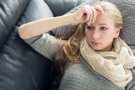 Young woman lies on the couchの写真素材