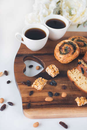 Two cup of coffee with sweet bread on the wooden tableの写真素材