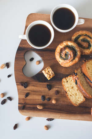 Two cup of coffee with sweets on the wooden tableの写真素材