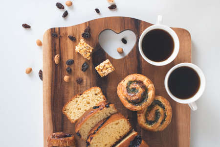 Two cup of coffee with sweet bread on the wooden tableの写真素材