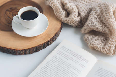 White table with cup of coffee and book on itの写真素材