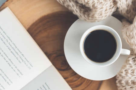 Cup of black coffee and book on the wooden tableの写真素材