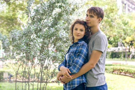 Young men hugging his girlfriend outdoorsの写真素材