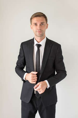 Portrait of a handsome business man, isolated on grey backgroundの写真素材