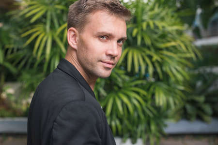 Attractive elegant man looking back to the cameraの写真素材