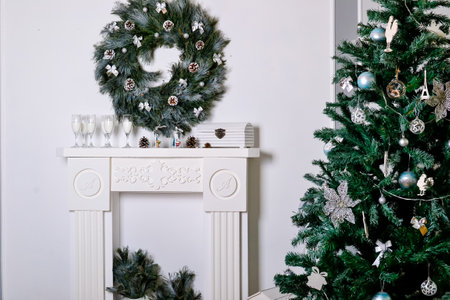 Beautiful living room interior with a fireplace. Christmas celebration. modern style interior of fireplace with christmas tree and presents in white. interior design about copy space or work space for your text in and Christmas party or happy new year concept with Christmas tree on white backgroundの写真素材