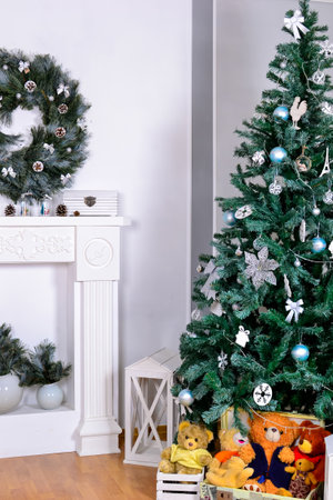 Beautiful living room interior with a fireplace. Christmas celebration. modern style interior of fireplace with christmas tree and presents in white. interior design about copy space or work space for your text in and Christmas party or happy new year concept with Christmas tree on white backgroundの写真素材