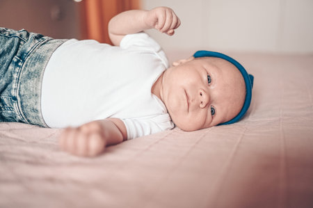 A baby lying on a bed. High quality photo