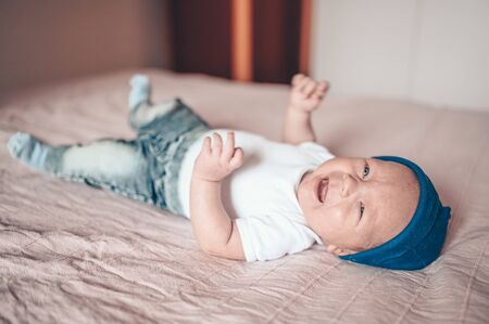 A baby lying on a bed. High quality photoの写真素材