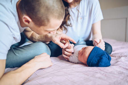 A young boy sitting on a bed. High quality photoの写真素材