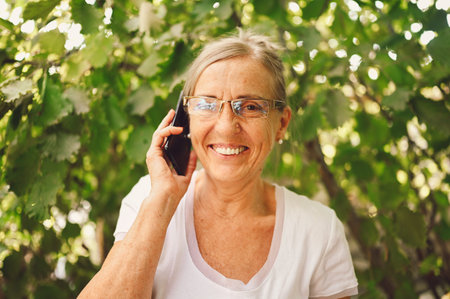 Technology, old age people concept - elderly senior old happy smiling woman in prescription...