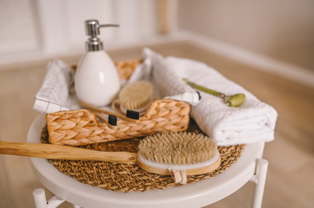 Zero waste bathroom accessories flat lay wooden desk background, spa body care concept. Natural sisal body brushes dry massage quartz facial roller, black bamboo toothbrushes. Eco-friendly lifestyleの写真素材