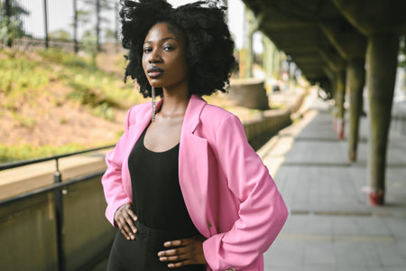 Fashion outdoor street style portrait of Beautiful young African American woman posing outside on...