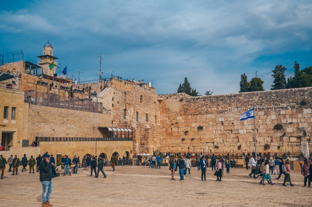 November 27, 2022 - Jerusalem, Israel. Tourist crowd and Jewish gather for Shacharit sunrise prayer at Old City Western Wailing Wall, holy place in Judaism. Temple Mount and Mount of Olives.のeditorial素材