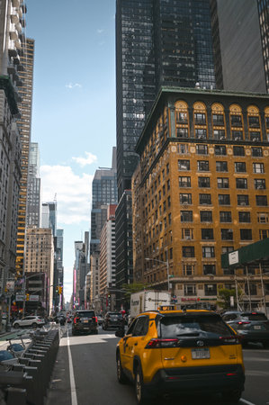 New York, USA, May 7 2023. Streets full of people crowd in Manhattan in the summer. Big city urban life concept background. Famous attractions places, touristic buses and yellow cabsのeditorial素材