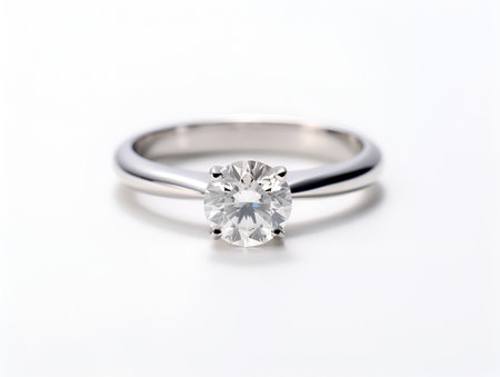 Diamond wedding ring on white background. White gold wedding ring with brilliant. Platinum diamond ring for wedding, engagement. Saint Valentine Day ring. Ring photo for ads or catalog, close-upの素材