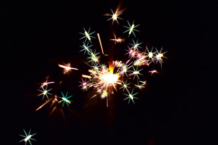 close up of a colorful sparkler with a dark background