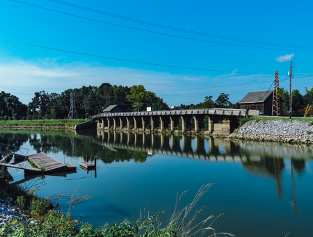 bridge reflecting on the water on a clear summer dayの写真素材