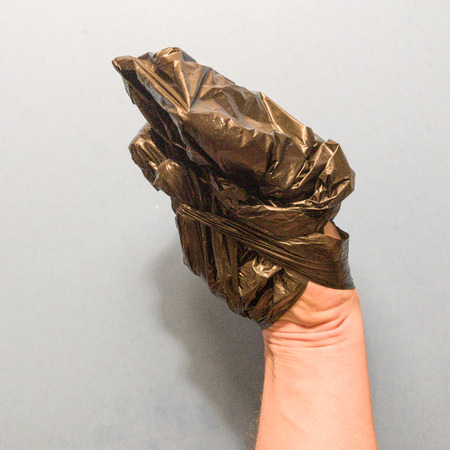 Hand wrapped in plasticの写真素材