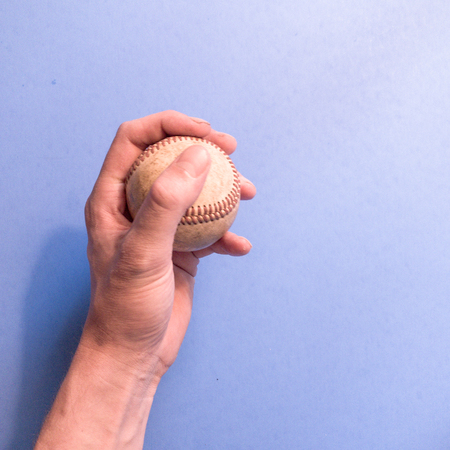 Hand holding a baseballの写真素材