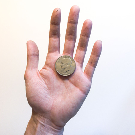 Hand holding an Eisenhower Dollarの写真素材