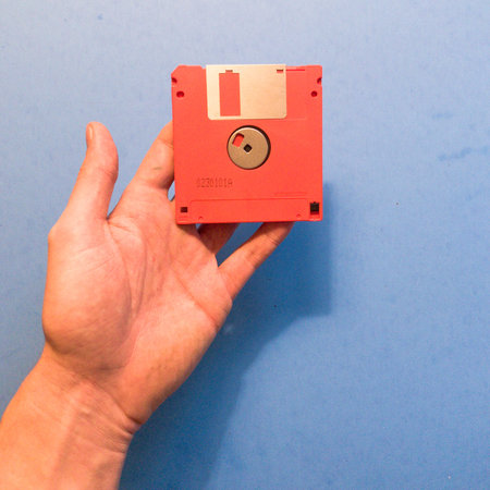 Hand holding floppy disk