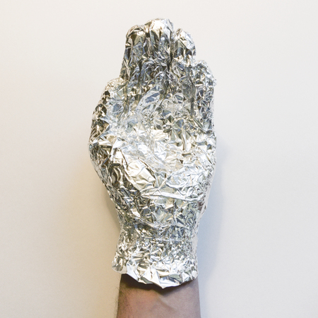Hand covered in foilの写真素材