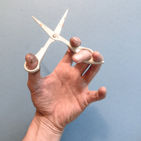 Hand holding scissors
