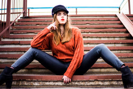 fashionable girl on the steps on the bridgeの写真素材