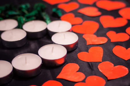 heart made of candles with green petals and postcards