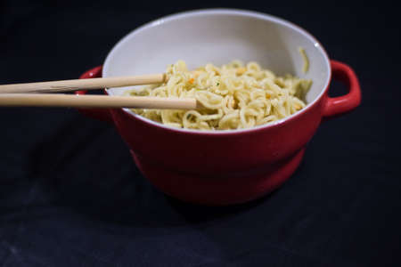 to take noodles with chopsticksの写真素材