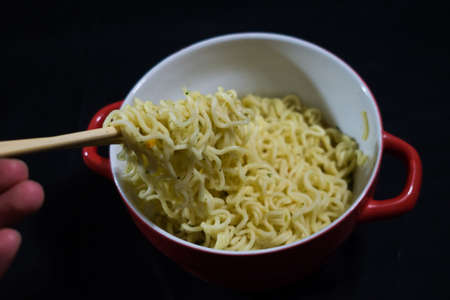 to take noodles with chopsticksの写真素材