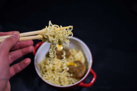 to take noodles with bamboo sticksの写真素材