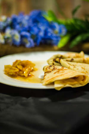 Pancakes. Maslenitsa. Candied fruit. Pancakes on a white plate with candied fruits.の写真素材