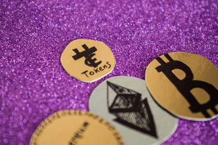 modern crypto currency on a violet shiny backgroundの写真素材